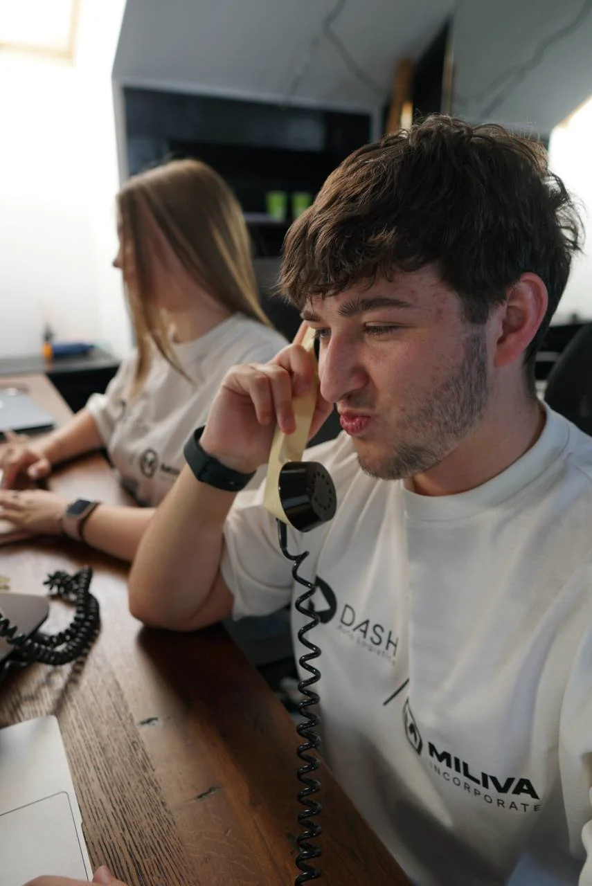 Miliva dispatcher on the phone in DASH x Miliva shirt