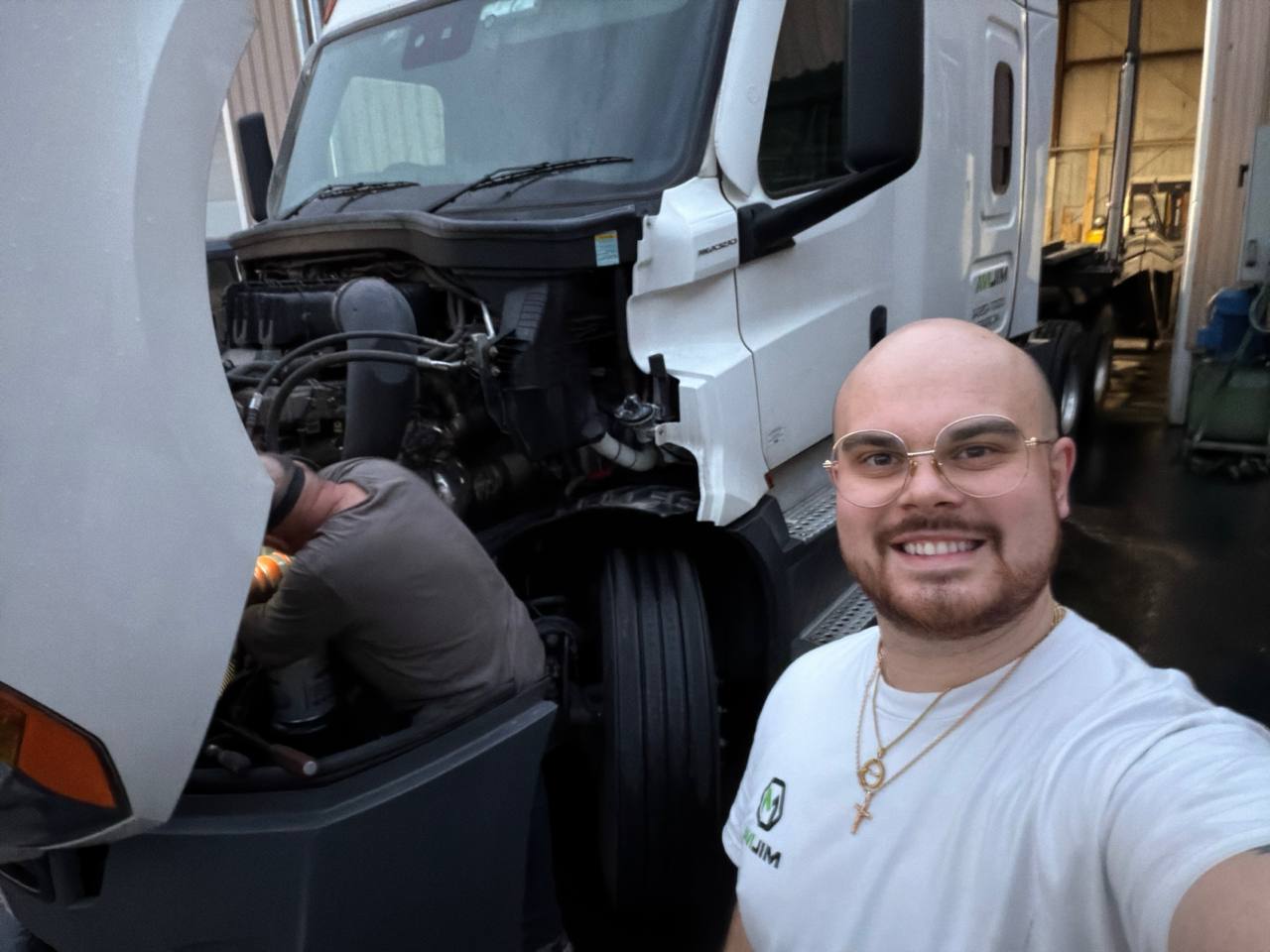 Miliva team member at the repair facility with truck under maintenance