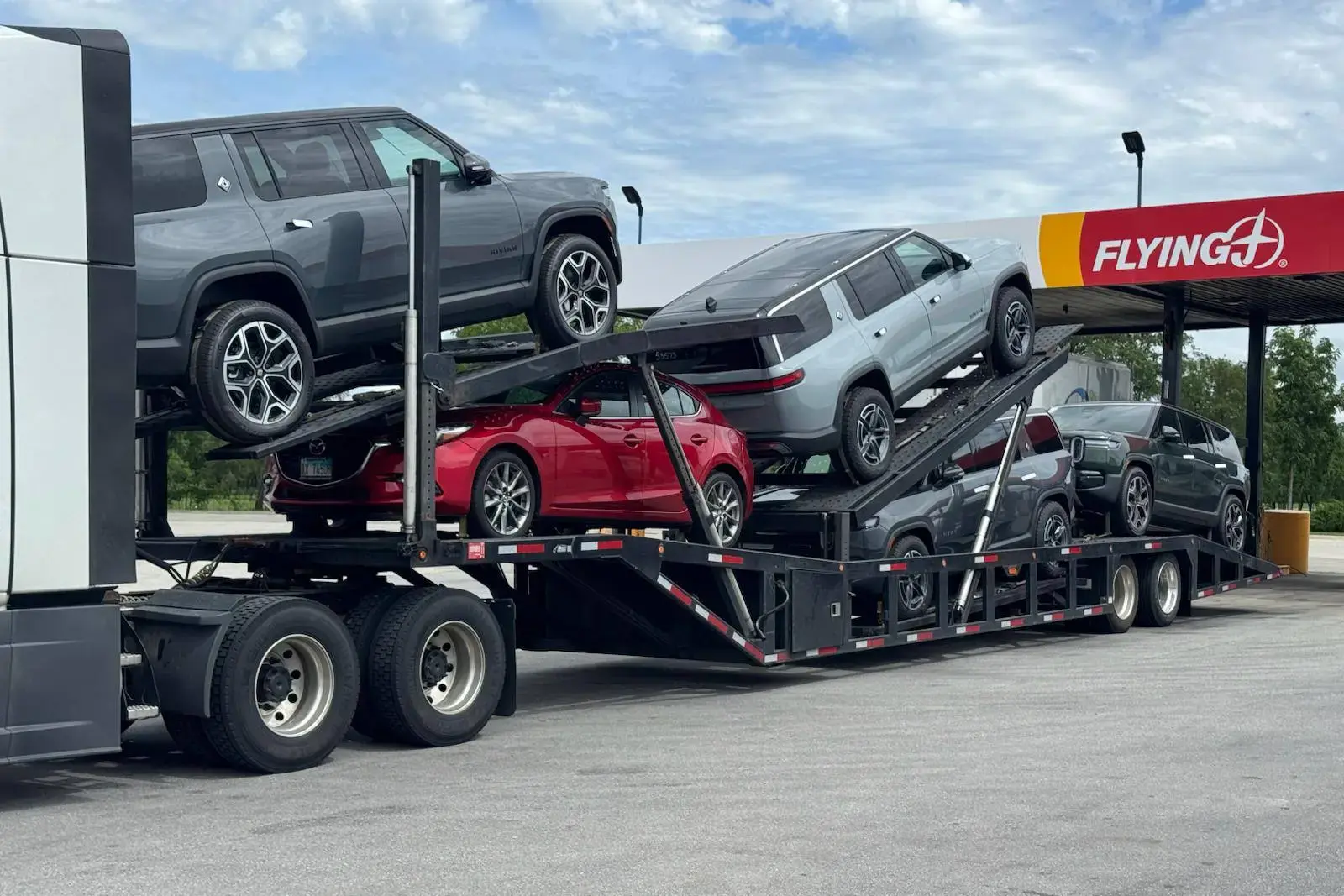IL to WA load — loaded car hauler at gas station